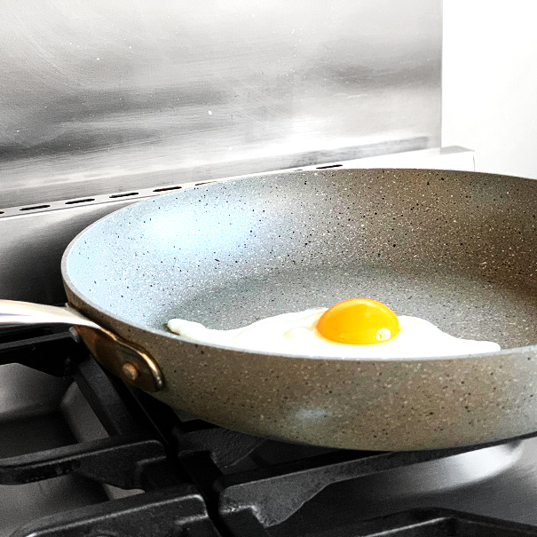 Ceramic coated frying pan cooking an egg sunny side up